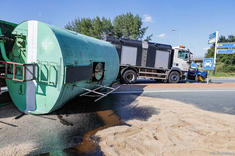 Aanhanger vrachtwagen kantelt op rotonde bij Hoogkerk, bitumen op de weg